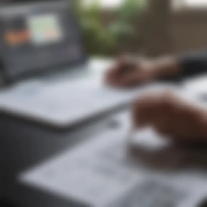 A close-up of someone reviewing financial documents and a laptop